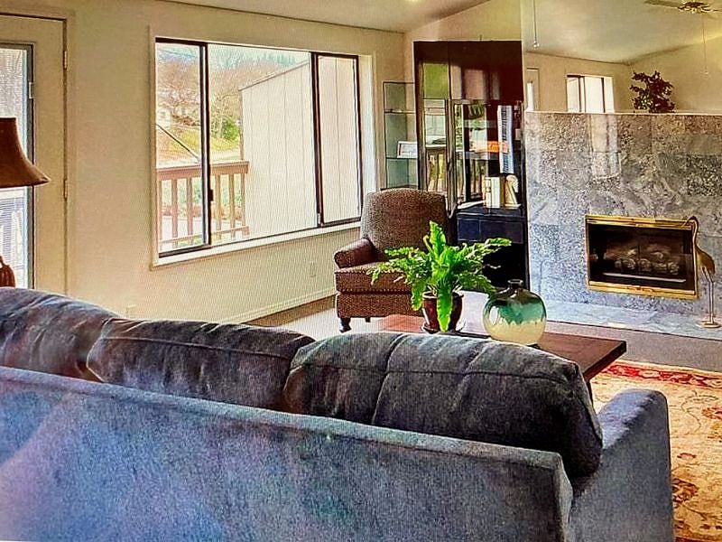 Living room with deck for warm weather and gas fireplace for toasty winter evenings