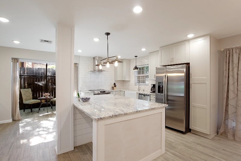 Open floor plan - Kitchen with large granite island with view to large TV and office area