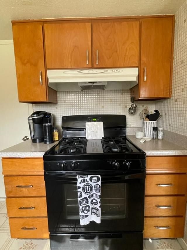 Gas Stove and Keurig coffee maker with milk frother.