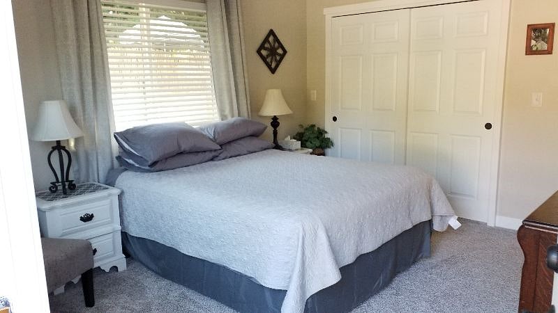 Roomy bedroom with comfy bed & large closet for storage.