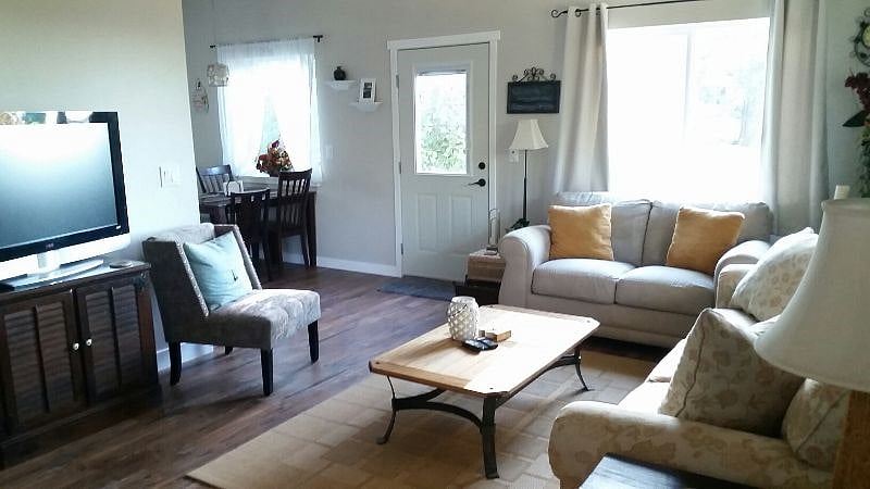 The open floor plan connects living room with kitchen and dining area