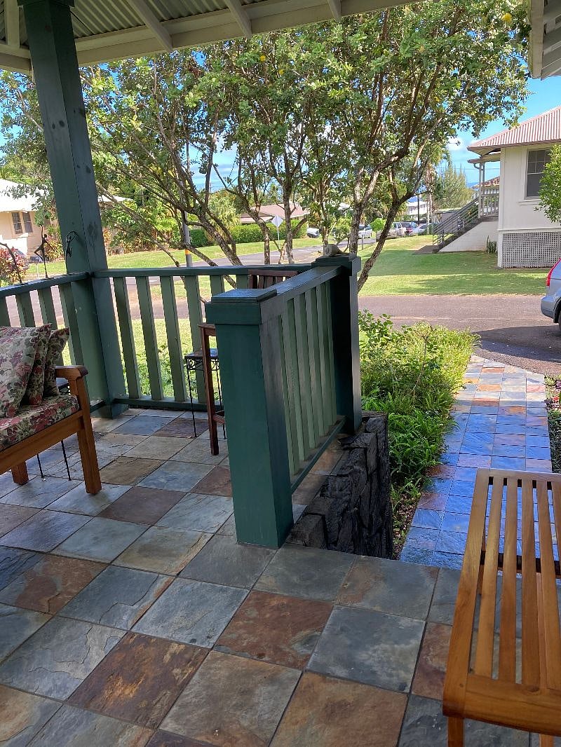 Looking down the front walkway toward the driveway and down the street/hill