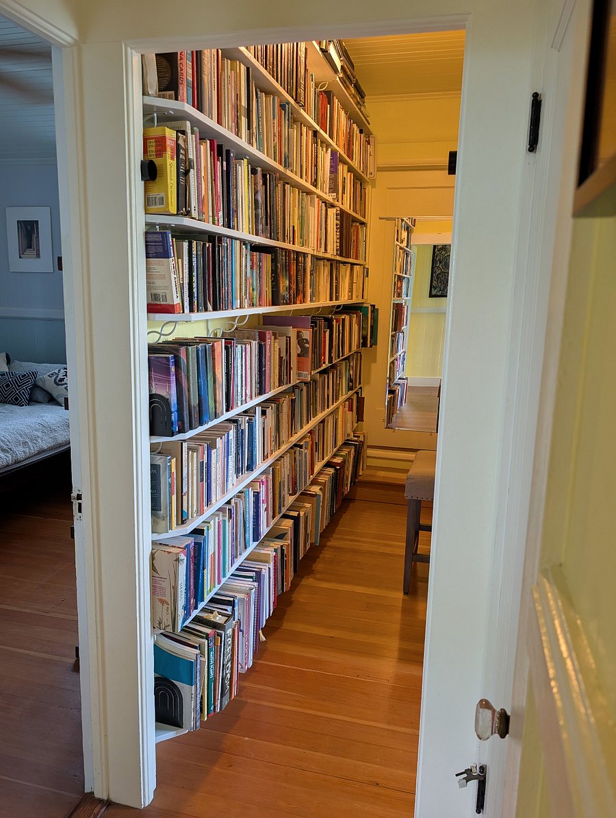 Hallway between extra bedrooms with library