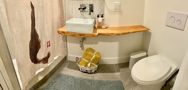 Bathroom has everything in it. The shelf is custom made from a tree that used to be on the lot.
