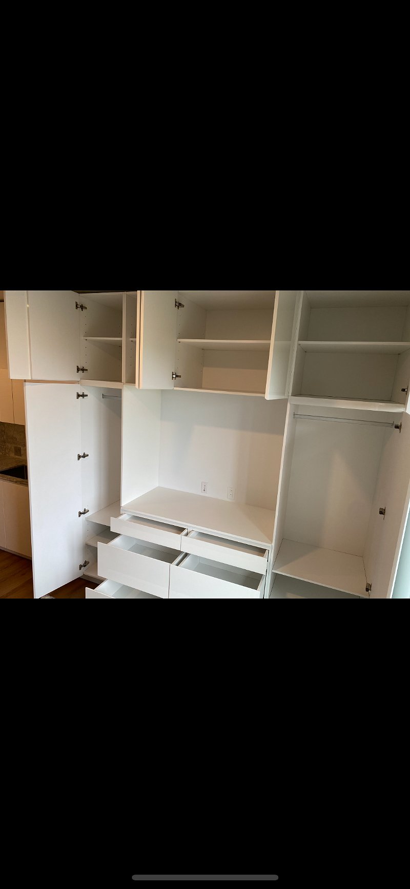 Lots of storage with built in cabinets on both walls.