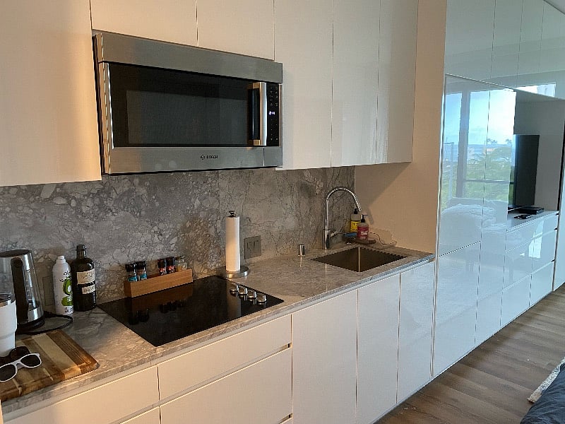 Kitchen area with Bosch microwave and stove. Pans and pots included.