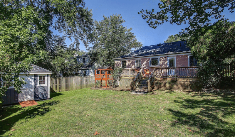 Enjoy the grill, firepit deck and child's play house in the serene fenced-in back yard