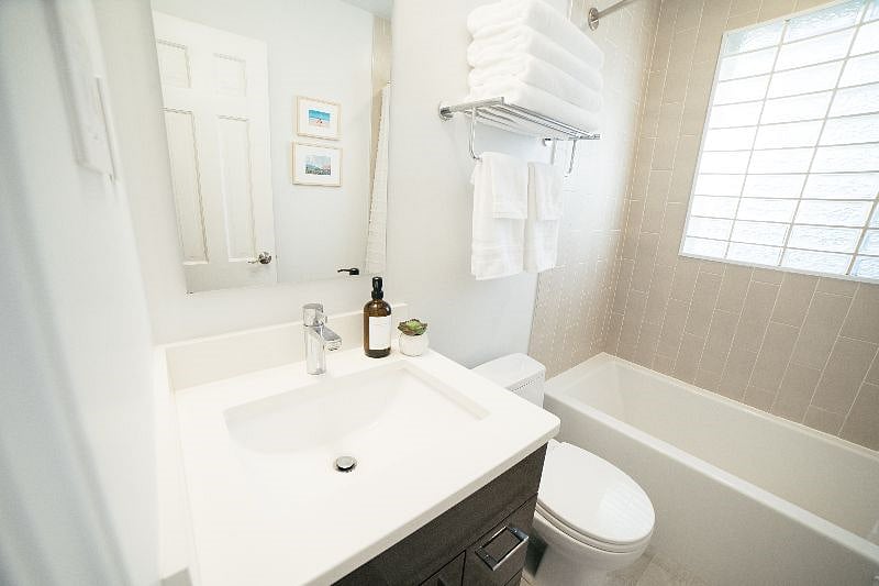 Newly renovated full bath with tub and rain shower on the main level