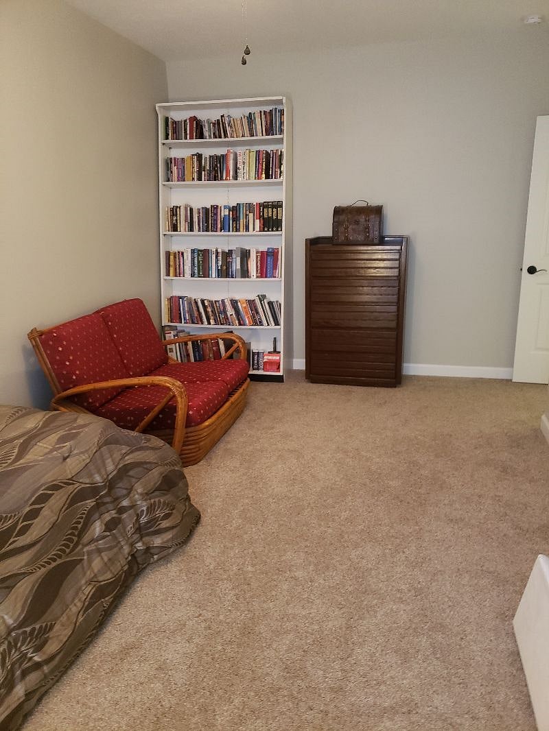 Bedroom with library and sitting area.