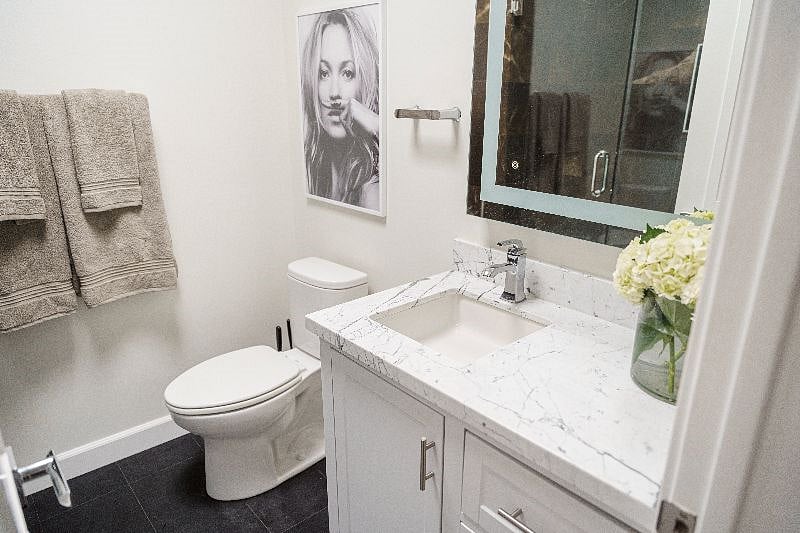 Private bathroom with shower + tub, real marble countertops, lots of counter/drawer space, light up mirror, and skylights in the ceiling for natural light.