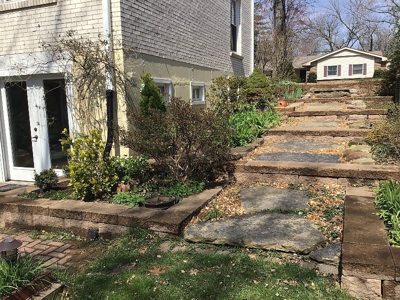 walkway on the east side of the house between flowerbeds on either side provides an abundance of color
