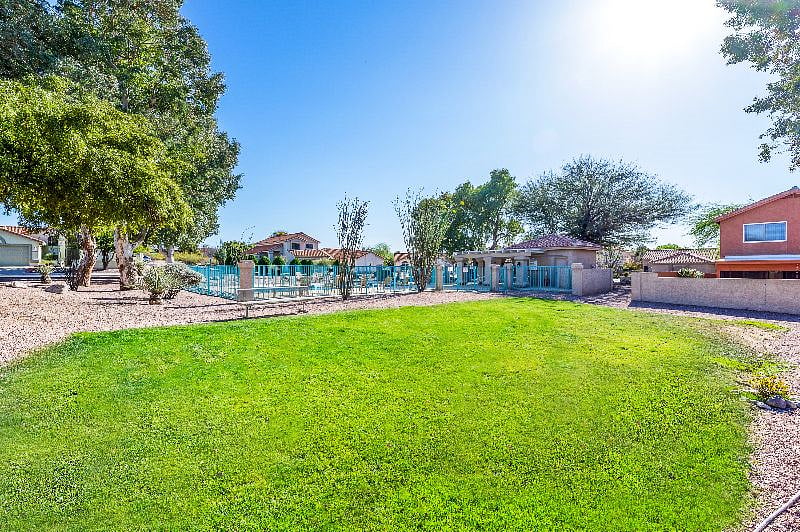 HOA maintained grass park area between home and pool