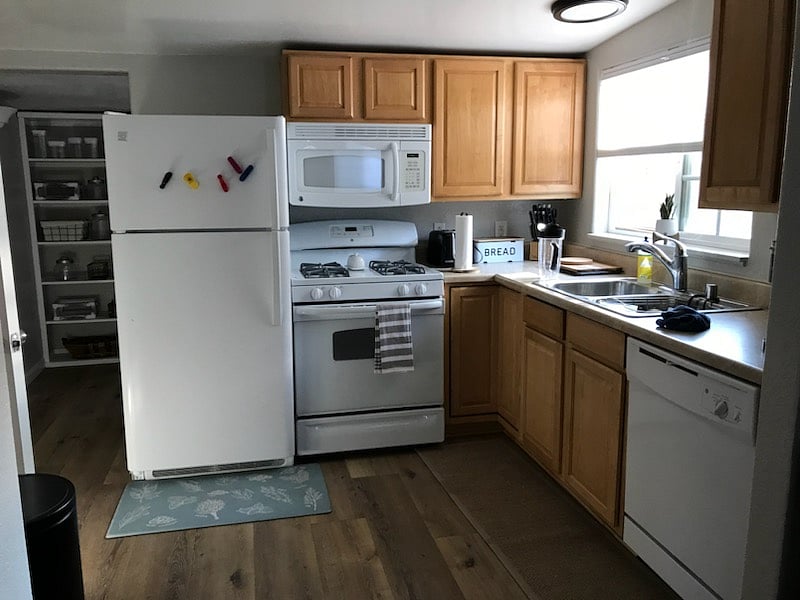 Kitchen with oven, stove, full sized fridge, garbage disposal and dishwasher