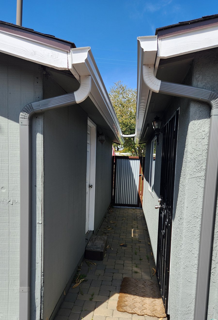 Walkway between garage and house. Behind metal gate and secure. Door on left is from garage.