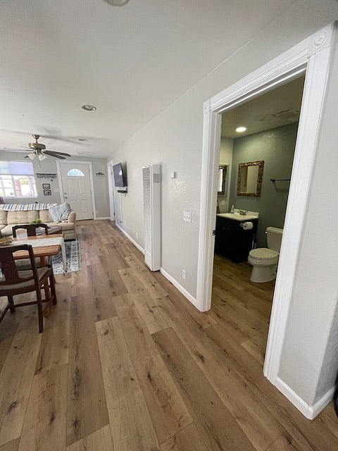 View of wall with wide screen and 2 bath on right.