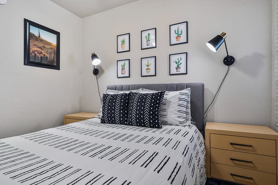 Our second bedroom is furnished with matching nightstands and bedside lighting, creating a cozy atmosphere with plenty of space to store all your belongings.