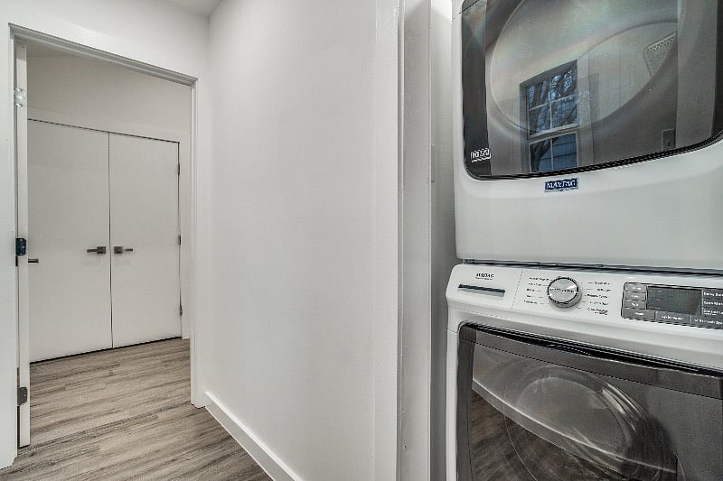 Stacked brand-new washer/dryer unit in hallway