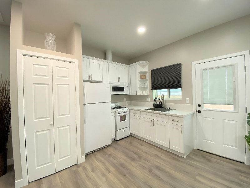 Full kitchen has 4 burner stove, oven, microwave and full size refrigerator.