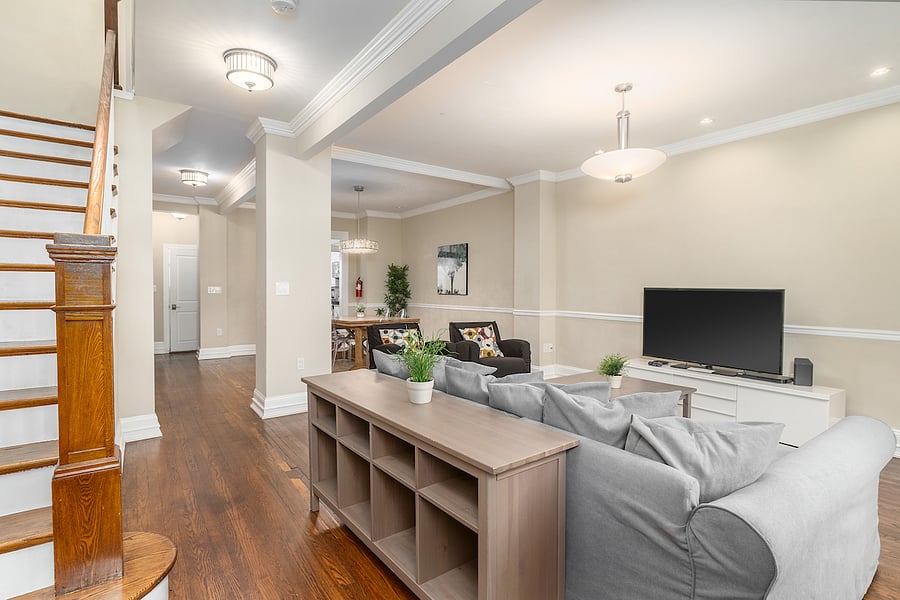 first floor area with view of staircase, tv room, dining area, and kitchen
