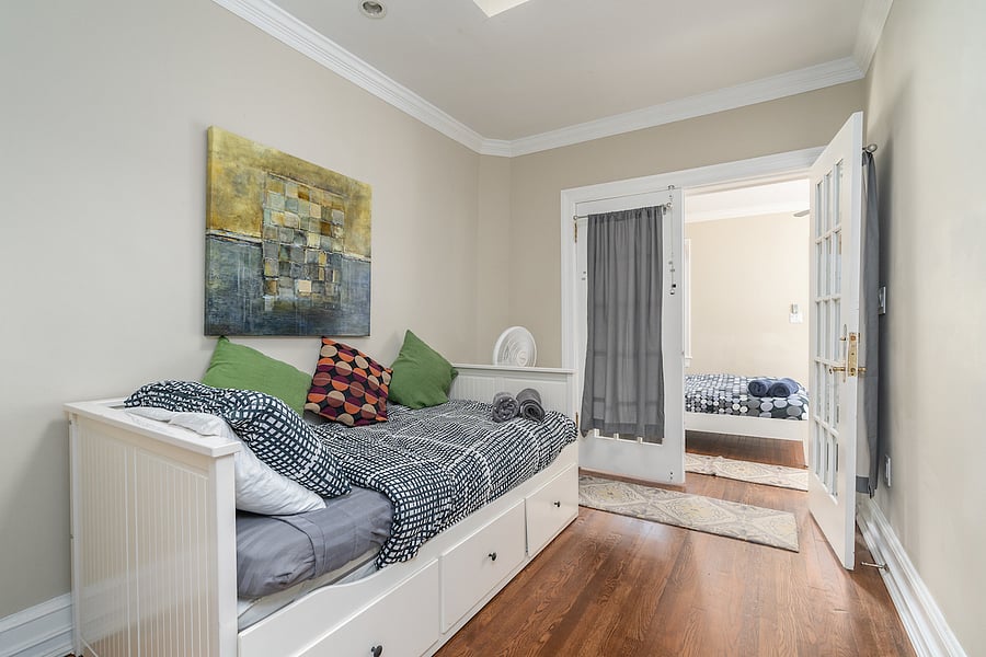 second floor middle bedroom with twin bed. bed can extend to two beds. you have to go through this room to get to the back bedroom with the patio. 