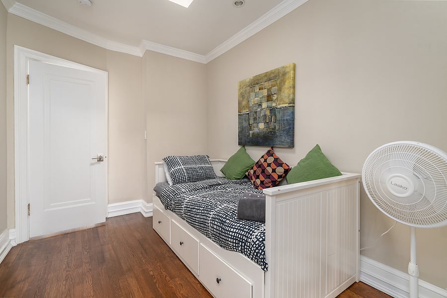 second floor middle bedroom with twin bed. you have to go through this room to get to the back bedroom with the patio. 