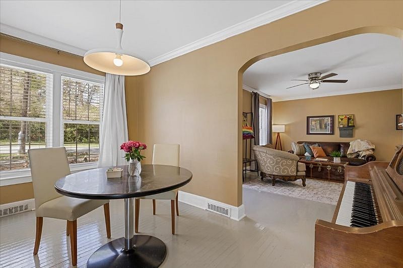 Dining room with piano at Hunsuckers Place, highlighting the homes music-centered character and warm, lived-in feel ideal for longer stays in Midtown Greensboro.