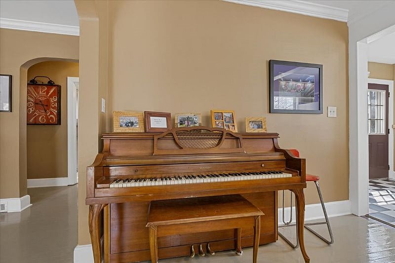 Dining room with piano at Hunsuckers Place, highlighting the homes music-centered character and warm, lived-in feel ideal for longer stays in Midtown Greensboro.