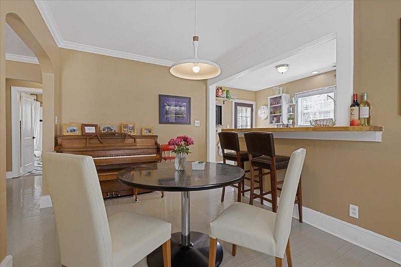 Dining room with piano at Hunsuckers Place, highlighting the homes music-centered character and warm, lived-in feel ideal for longer stays in Midtown Greensboro.