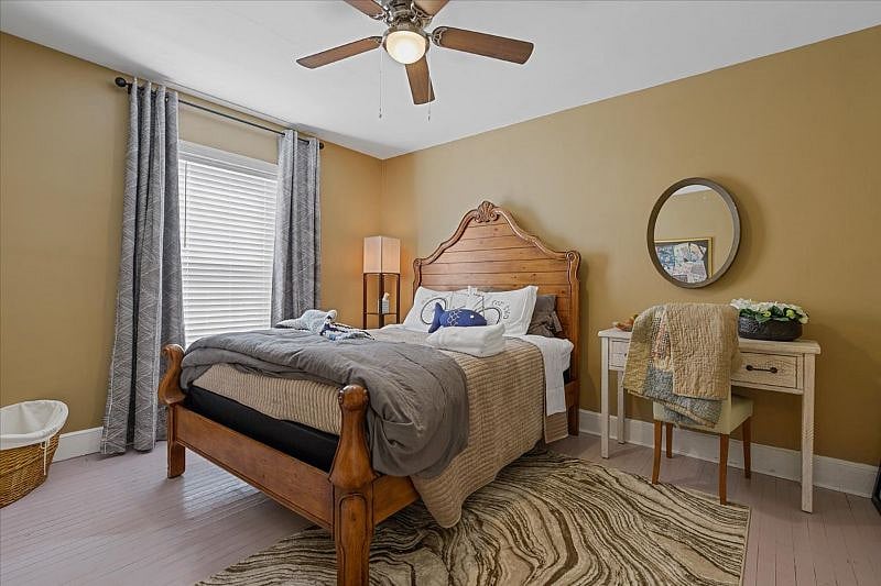 Primary bedroom featuring a comfortable bed with high-thread-count cotton linens, designed for rest and recovery after long work shifts in Greensboro NC.