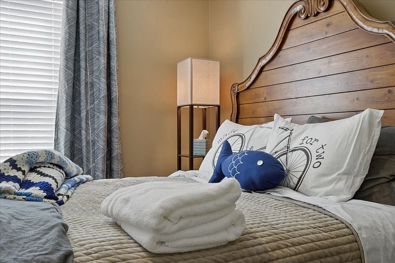 Primary bedroom featuring a comfortable bed with high-thread-count cotton linens, designed for rest and recovery after long work shifts in Greensboro NC.