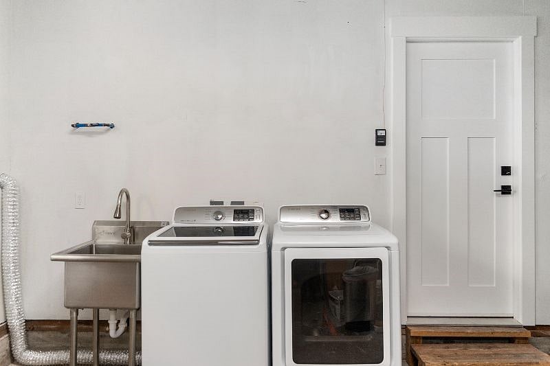 Brand new washer and dryer + utility sink located in the garage.