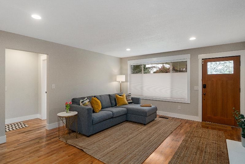 Couch ottoman opens for additional storage. Ottomans, coffee tables and artwork have been added since this photo.