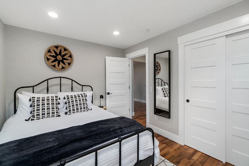 Bedroom 1 with queen bed + blackout shades.