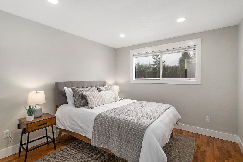 Bedroom 2 with queen bed + blackout shades.