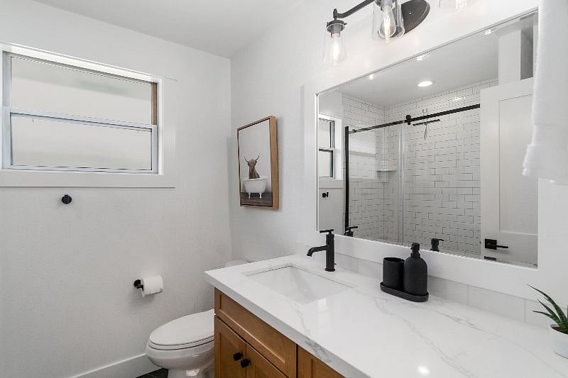 One bathroom with excellent lighting and heated floor!