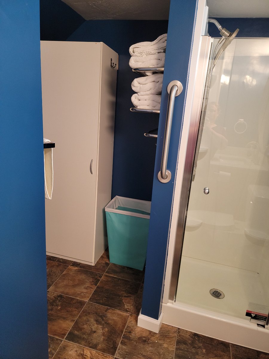 Large Shower with Hamper and Storage Cabinet