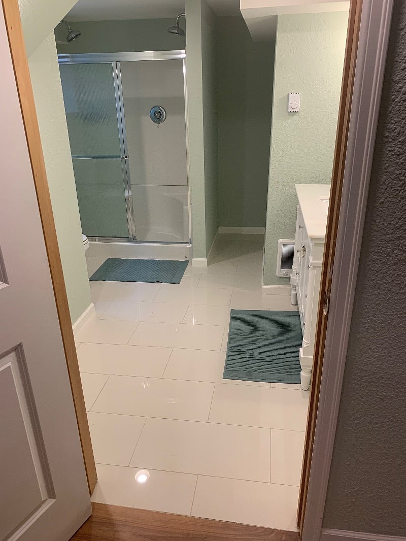 3/4 bathroom with double shower, new tile flooring.