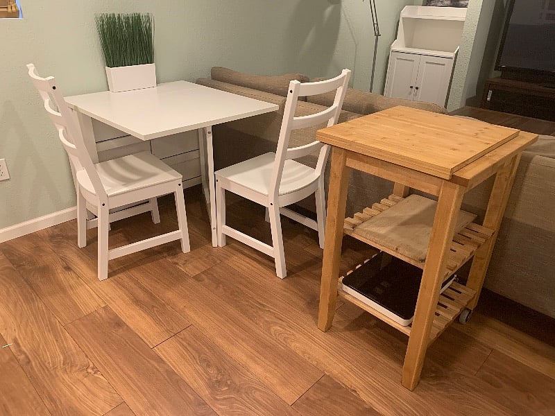 Expandable dining table with drawer storage, rollable kitchen island with cutting board, spare induction stovetop.
