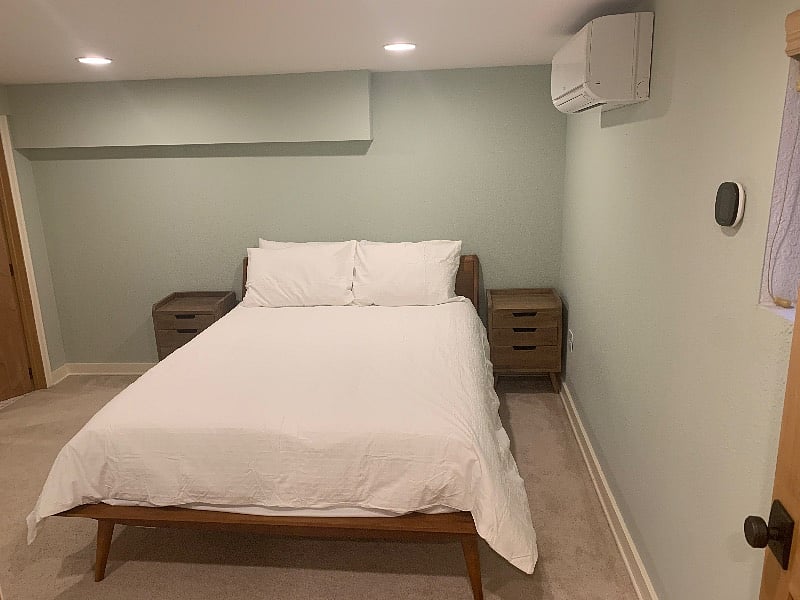 Carpeted bedroom with Queen bed with memory foam + pillow-top mattress, separate zoned ductless air conditioning, heating with smart thermostat. (Not shown: nightstand lamps included)