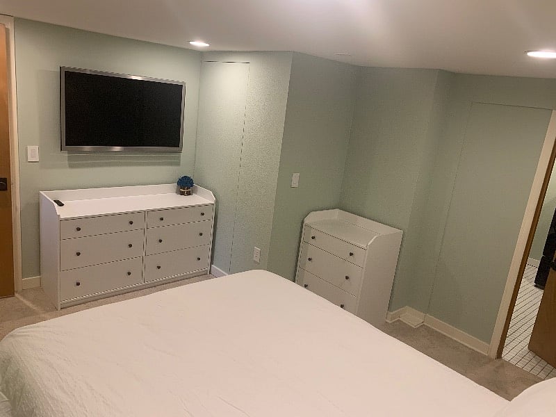 Wall-mounted LCD tv with Amazon Fire TV Stick, storage via 2 dressers.