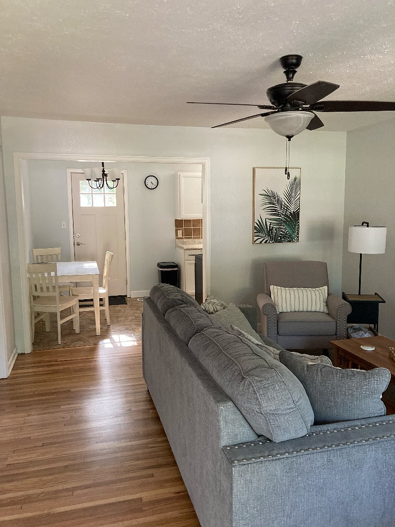 Living area into kitchen, with dining table and chairs. Door to back yard which has the added security of Ring Floodlight/Camera