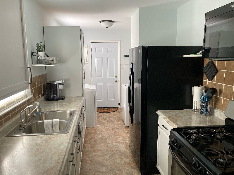 Fully stocked kitchen with appliances.