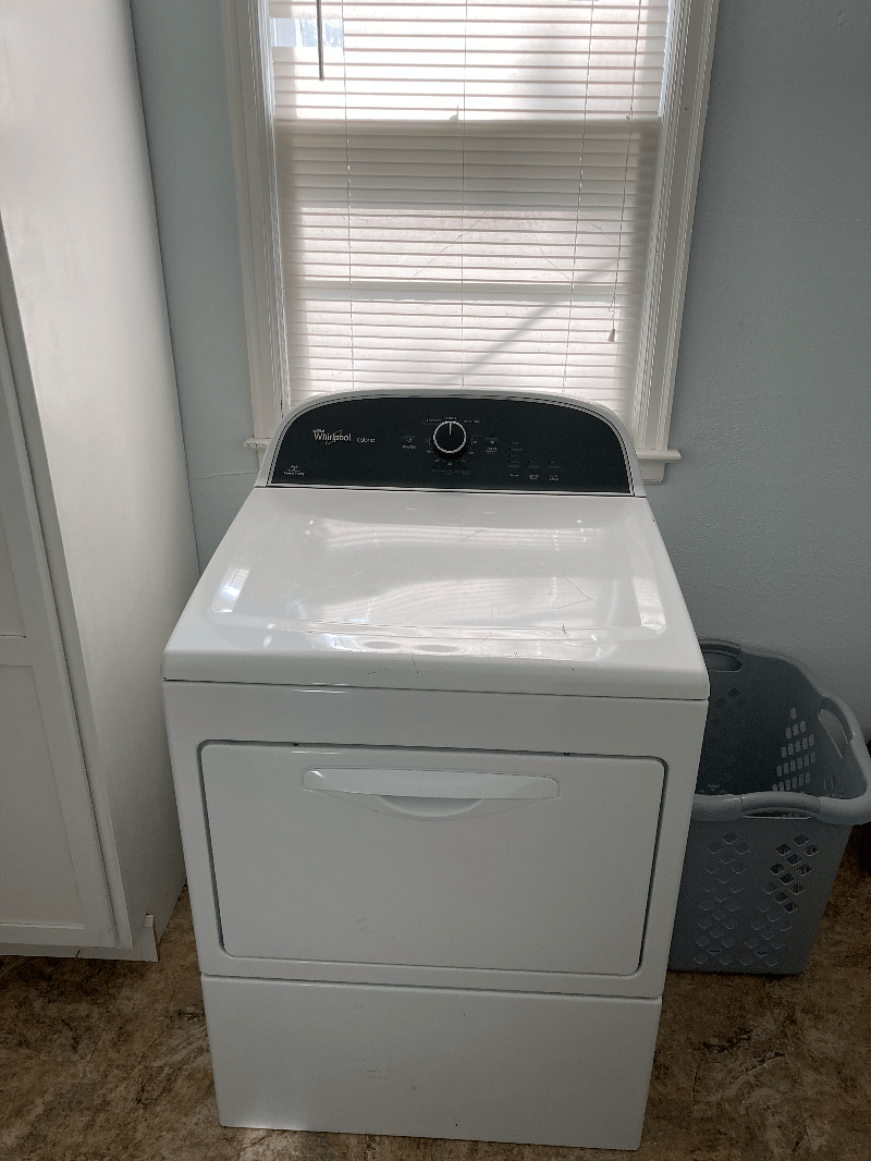 Whirlpool dryer with laundry baskets.