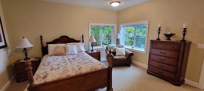 Bedroom with two windows for light.
