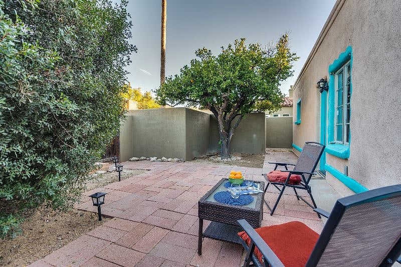 Enjoy your morning coffee by the orange tree.