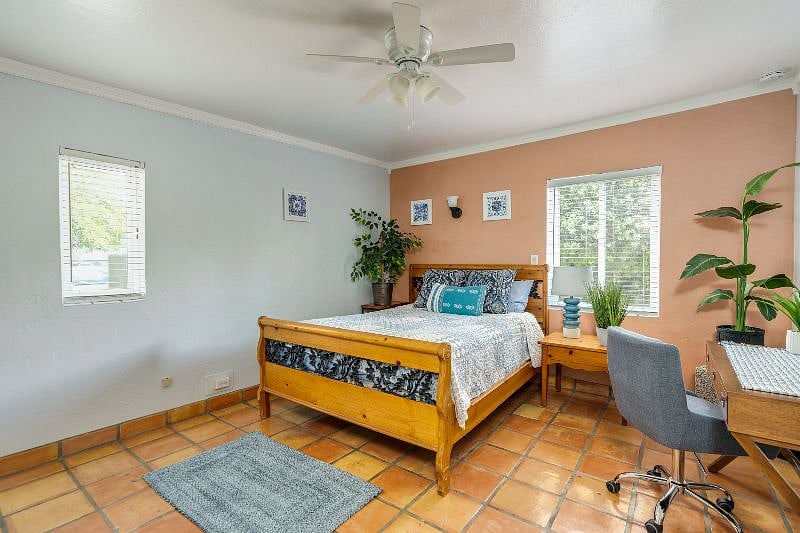 Master bedroom includes a queen bed, large closet, desk and private bathroom