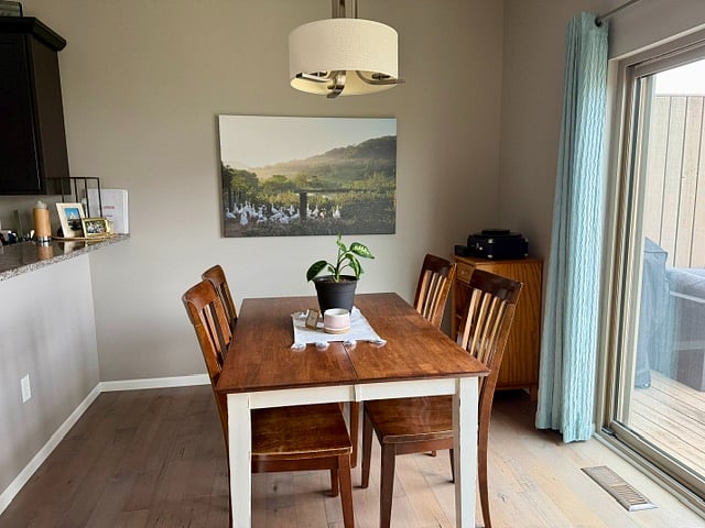 Dining room with wine cabinet and glasses. Table folds out to seat 6.