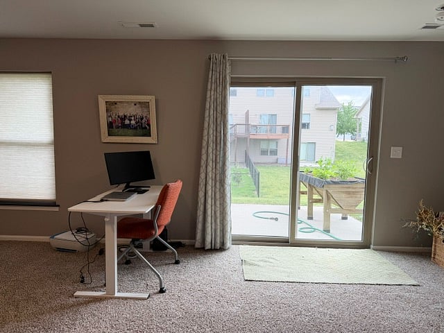 Stand/sit desk in large finished basement with walkout patio.