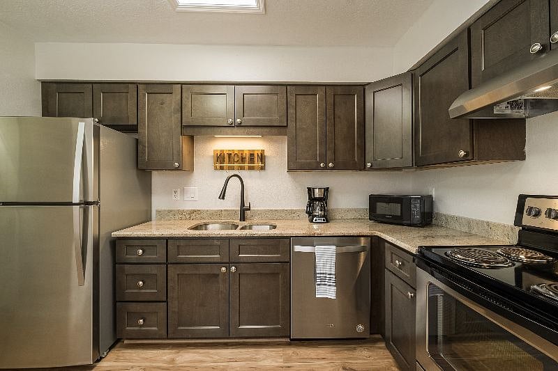 Brand new kitchen with stainless steel appliances.
