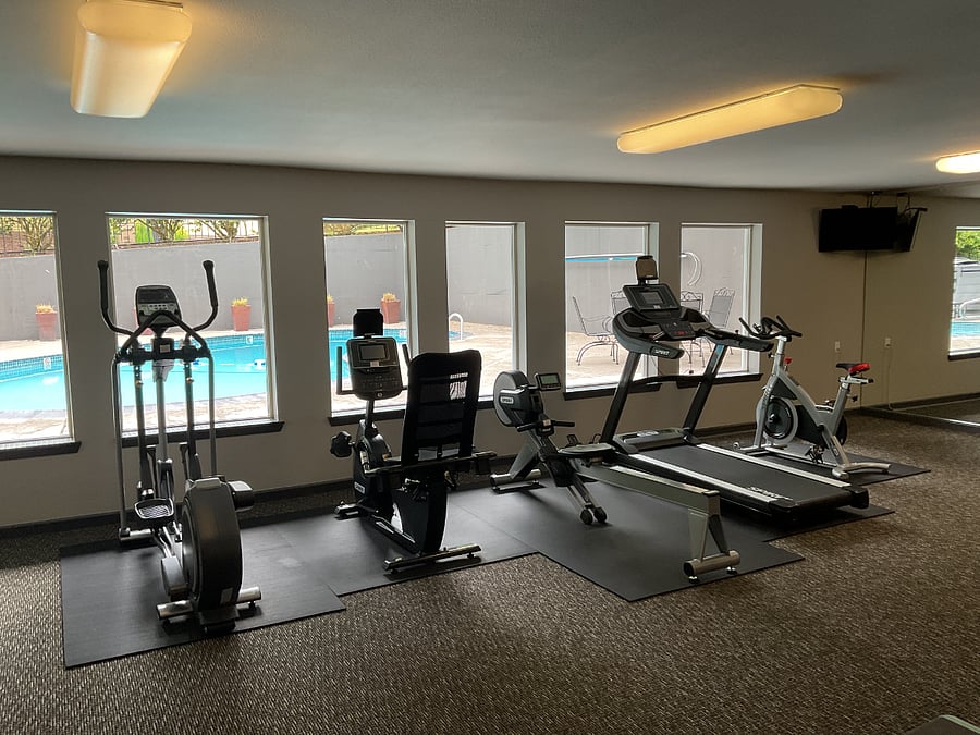 Modern gym equipment. The gym looks out onto the 2nd pool available to residents and their guests.